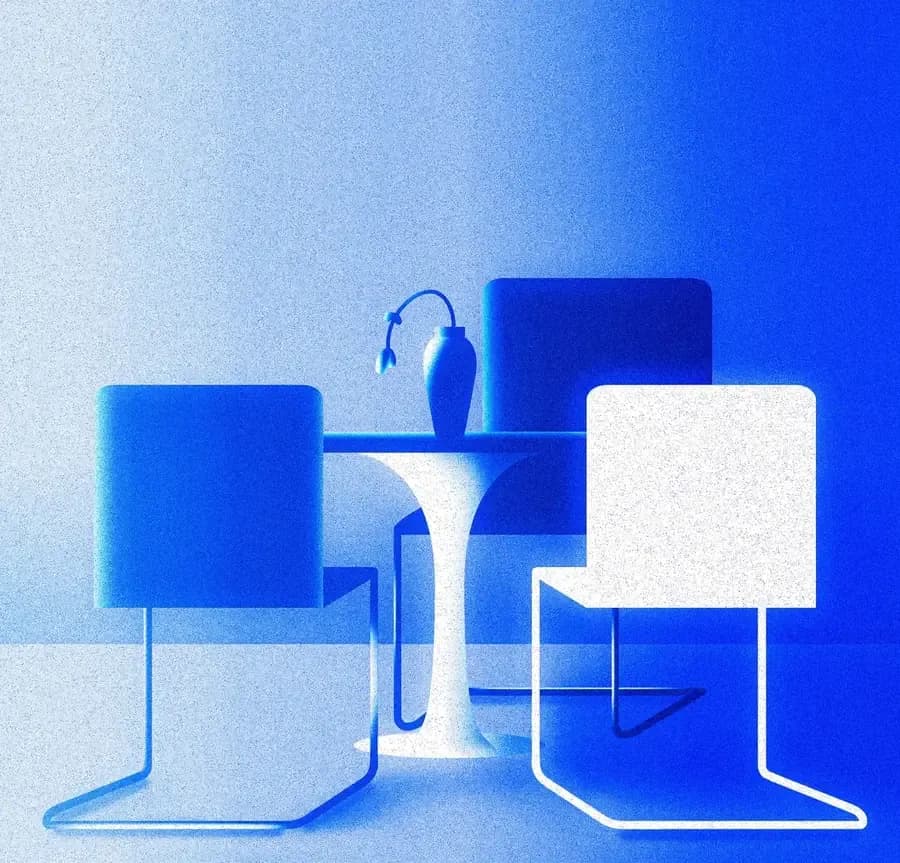 Chairs gathered around a small table with a vase, in grainy shades of blue